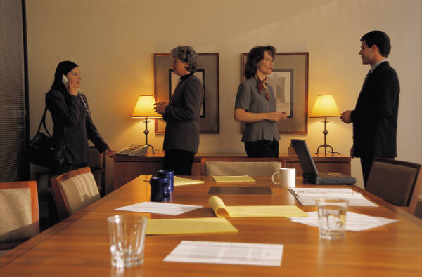 Boardroom meeting with members greeting one-another