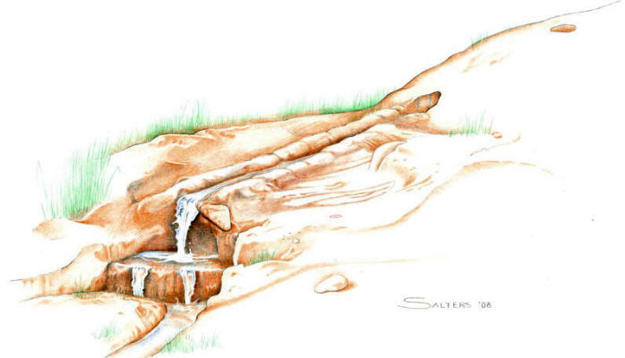 A kareez channel emerging from its underground (right) to its above ground section (left)