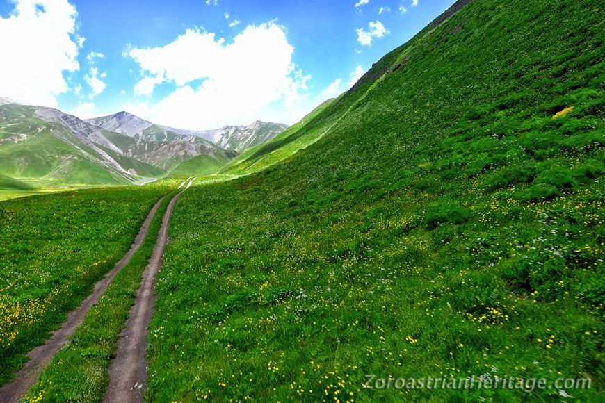 Road from Khinalig village to the Atashgah site with the alpine meadows in bloo